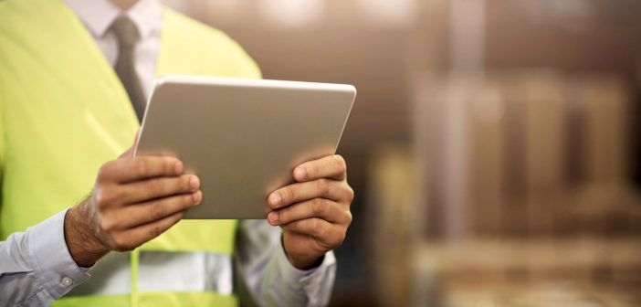 Closeup shot of an unrecognisable man working on a digital tablet in a distribution warehouse